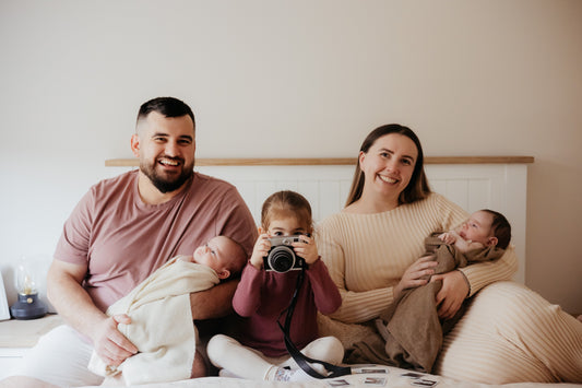 Mama with her three daughters and partner — the family behind the bilingual flashcards, celebrating language, love, and learning together.