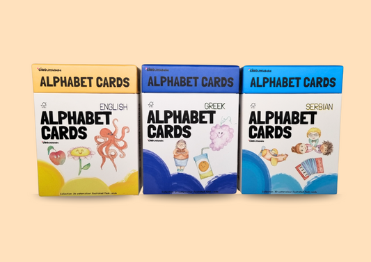 Bilingual flashcard decks for toddlers featuring Serbian, Greek, and English cards placed side by side to showcase one picture-one word design.